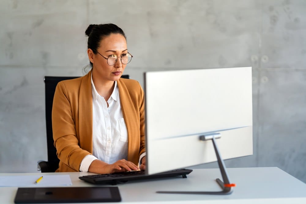 Business professional reviewing supplier qualification at a desk