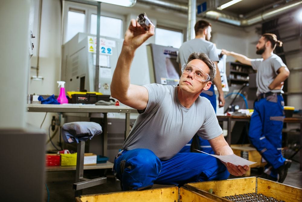 Engineer and workers carrying out quality control in a factory