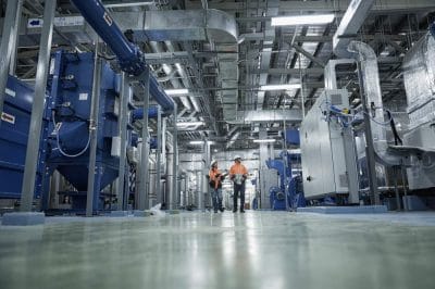 Engineers inspecting a modern manufacturing facility