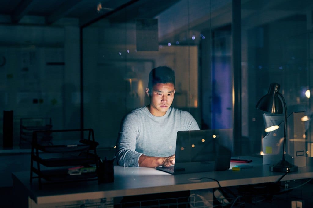 Purchasing agent working late at a computer on an industrial parts order