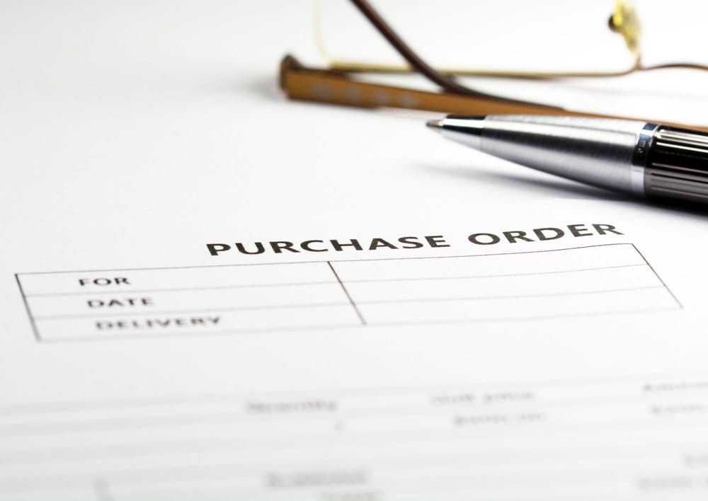Purchase order form with a pen, ready for approval
