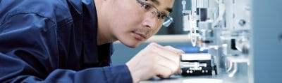 Engineer performing quality inspection on electronic components