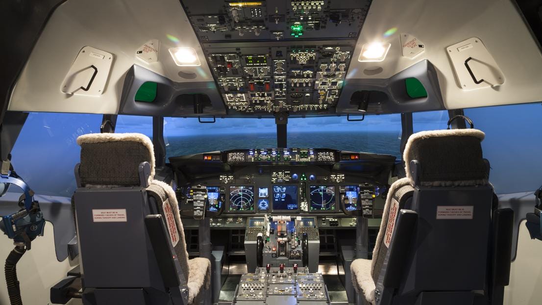 Pilot seat and flight controls in a flight simulator cockpit