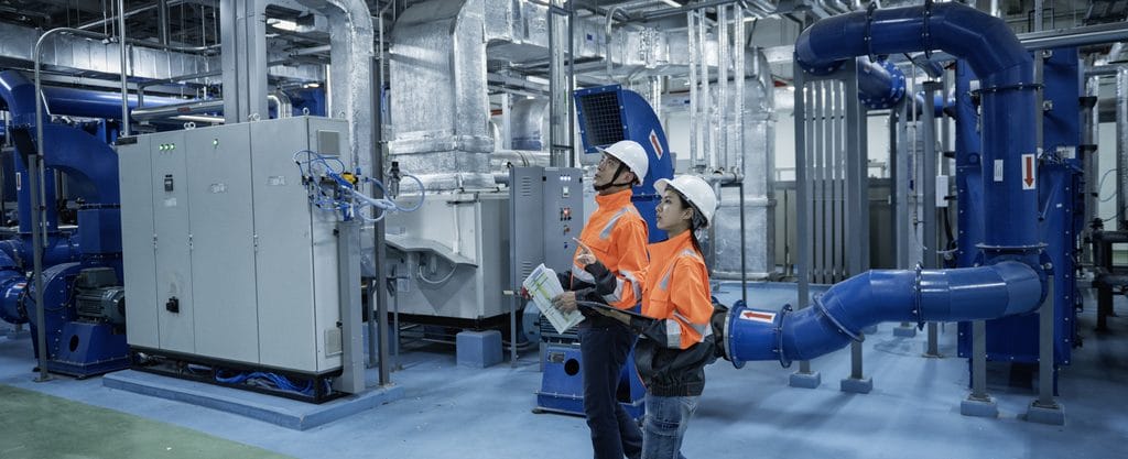 Two engineers inspecting a modern industrial facility