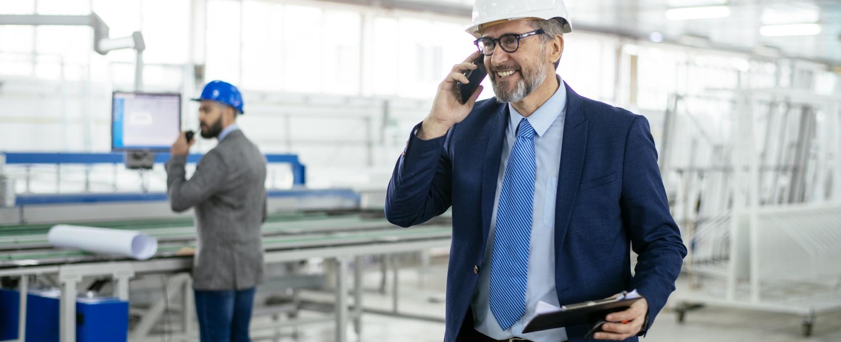 Senior engineer on the floor of a factory