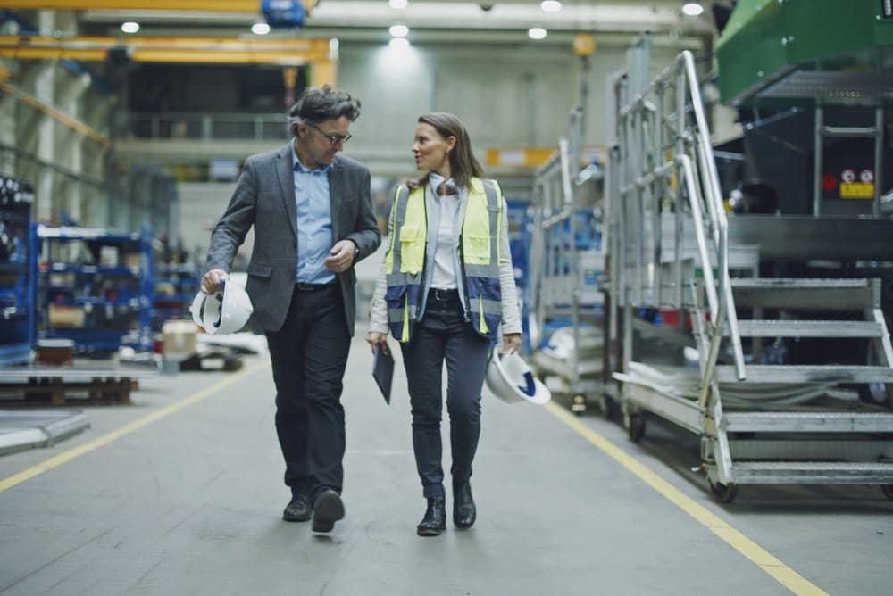 Engineers walking together through a factory