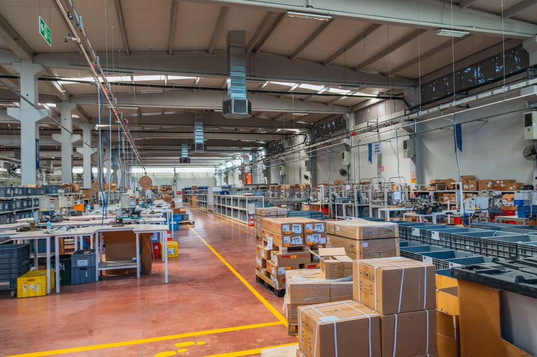 Modern factory interior with production line machinery and packaged boxes