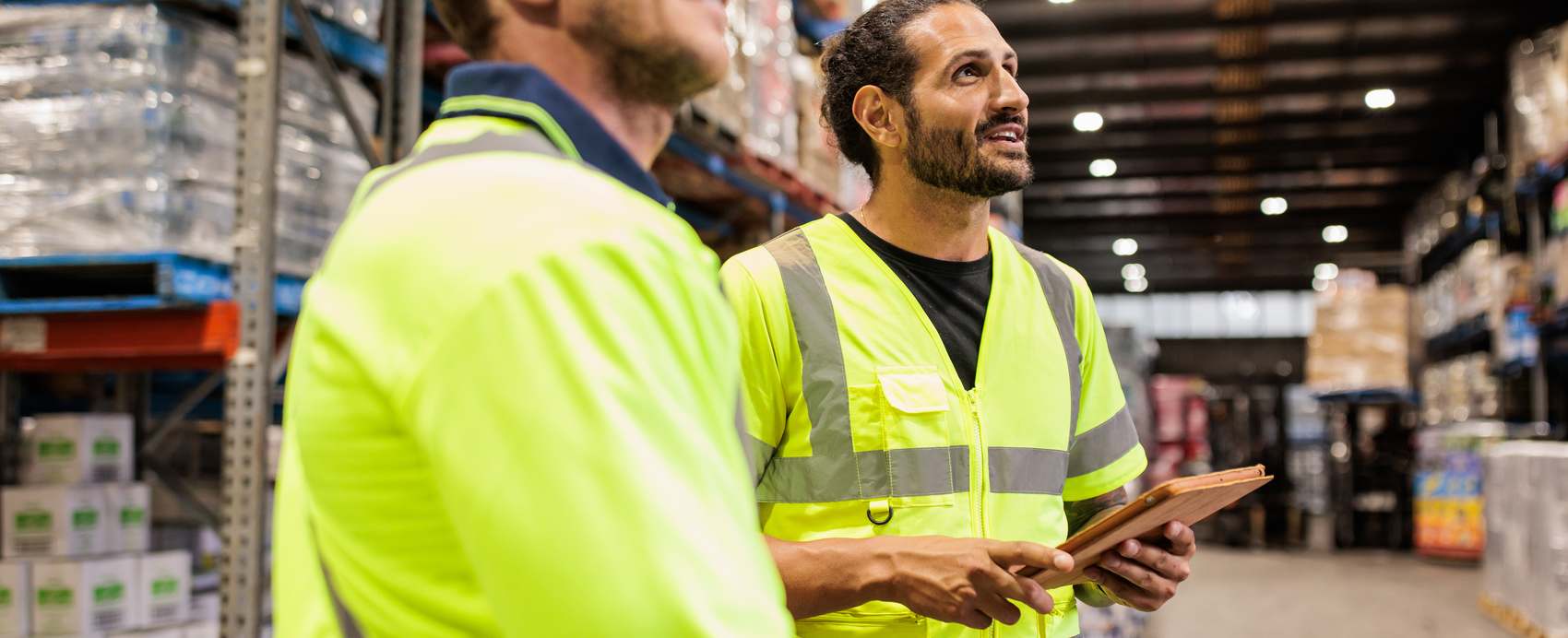 Warehouse staff checking inventory on a digital tablet