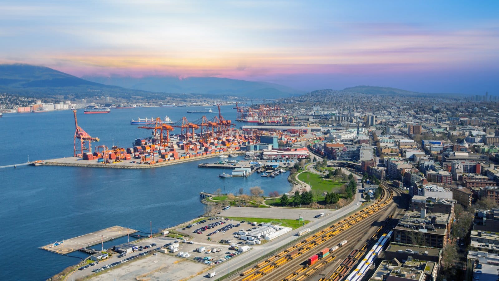 Aerial view of a container terminal with rail lines and cargo ships